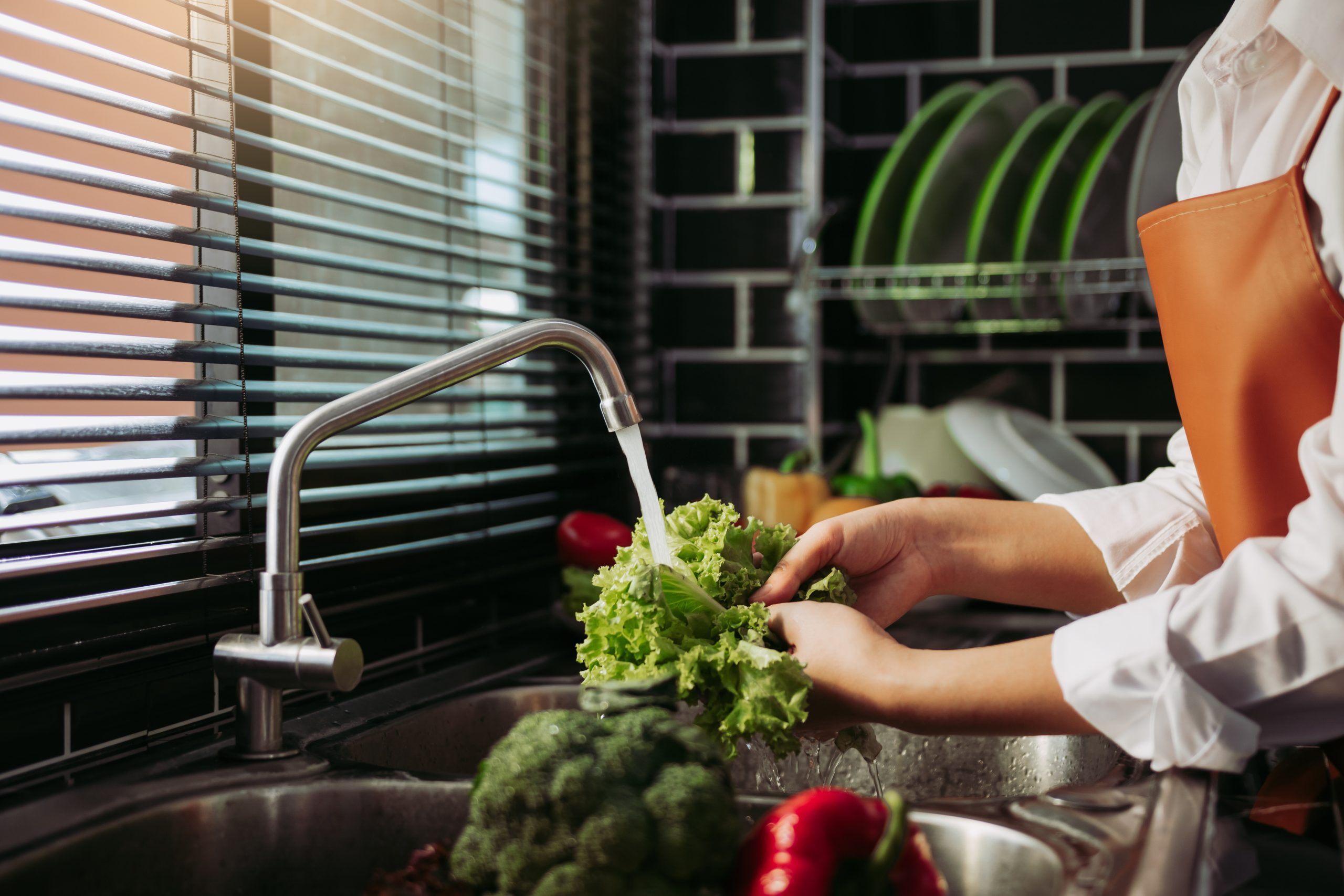 Asian hands woman washing vegetables salad and preparation healt